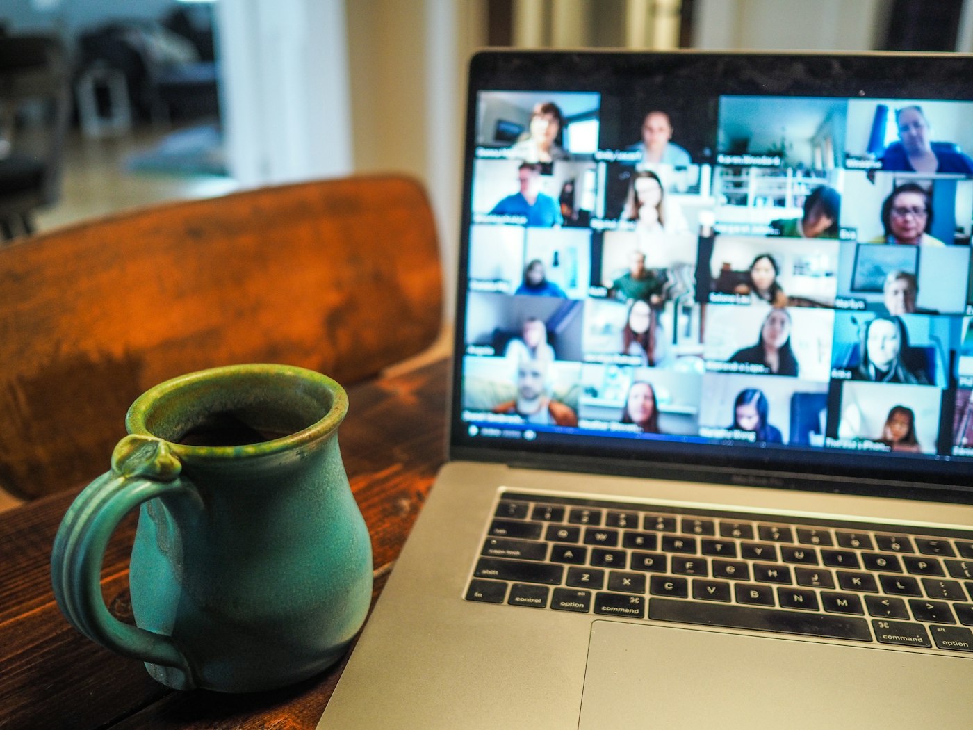 A laptop showing a video call with several people